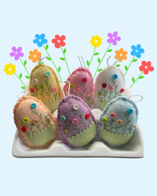 Six eggs made out of sewn felt with flowers made out of buttons and embroidery stitches.